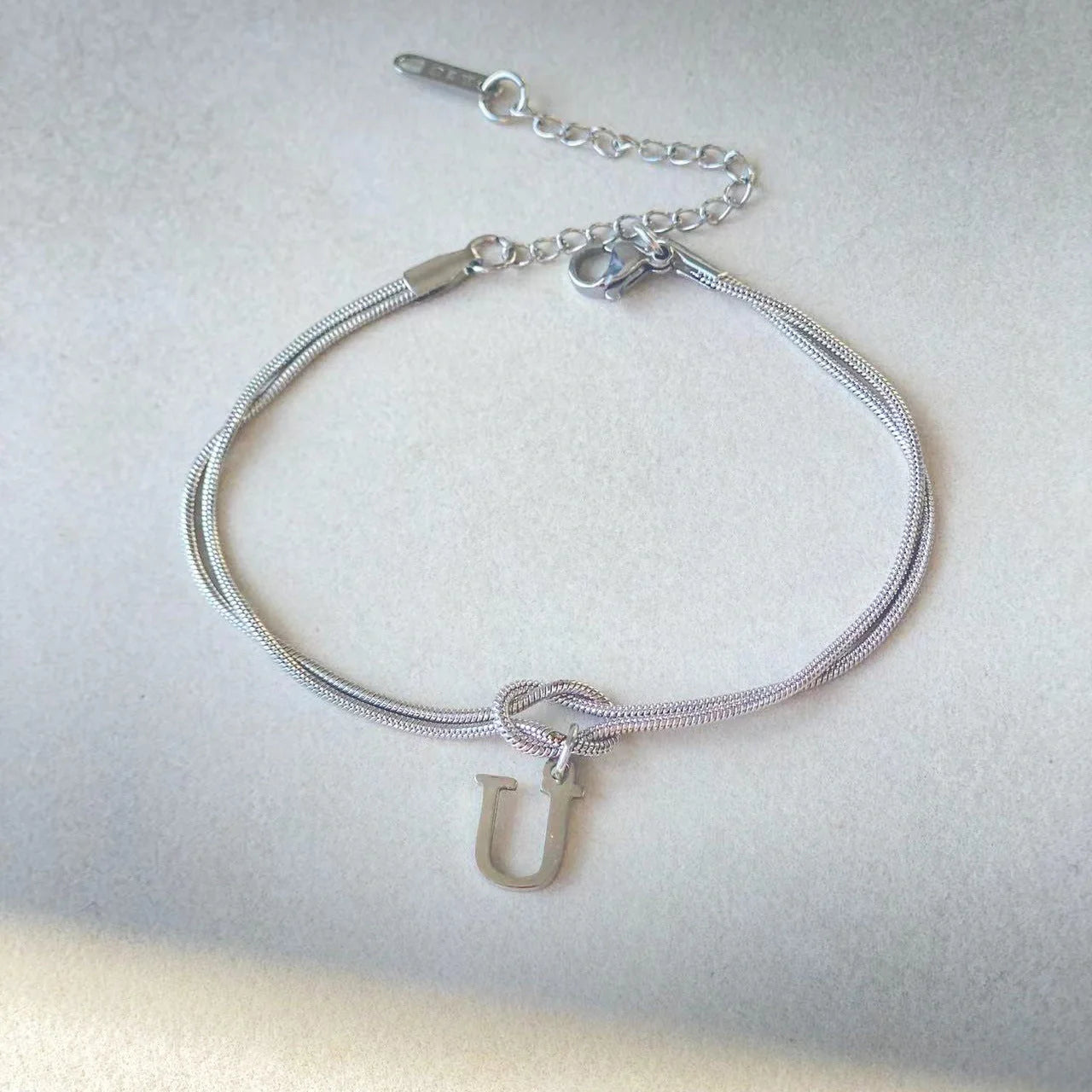 Personalised gold and silver love knot bracelets for couples, perfect as Valentine's Day gifts.