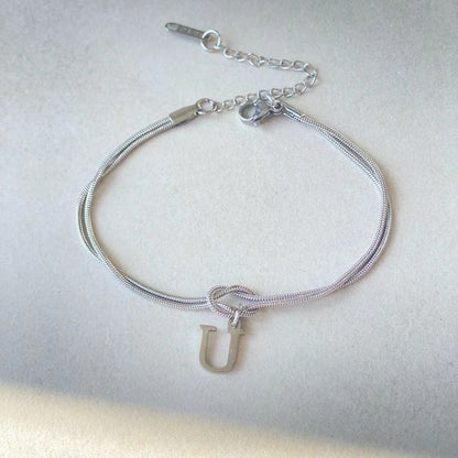 Personalised gold and silver love knot bracelets for couples, perfect as Valentine's Day gifts.