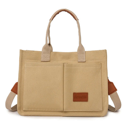 Stylish and durable canvas tote bag with multiple pockets for everyday use