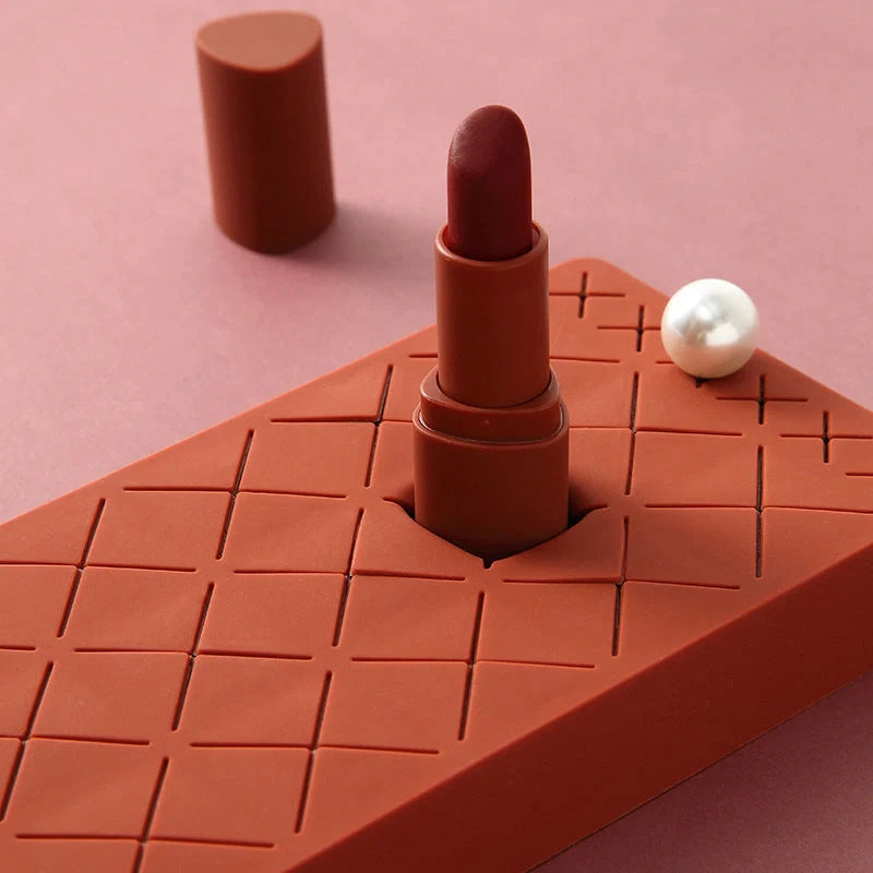 Silicone and ABS lipstick storage rack in red, pink, blue, and grey