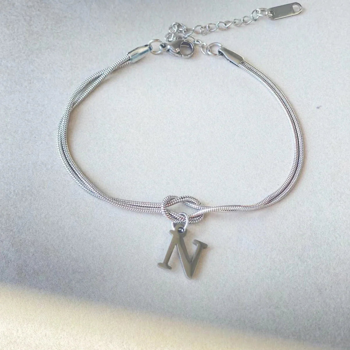 Personalised gold and silver love knot bracelets for couples, perfect as Valentine's Day gifts.
