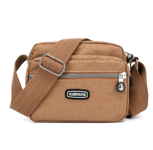 Small square messenger bag in water-repellent nylon with multi-compartment design