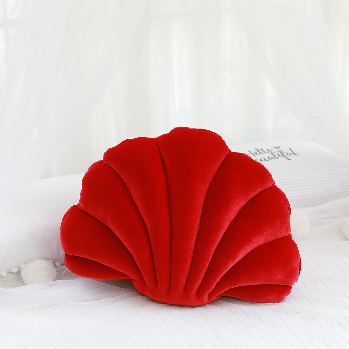 Cosy shell-shaped plush nap pillow in various colours and sizes for ultimate comfort