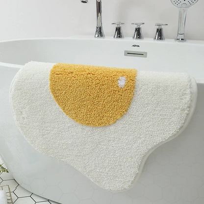 Quirky egg-shaped entrance mat made of absorbent polyester fabric with non-slip rubber backing, available in various sizes and colours