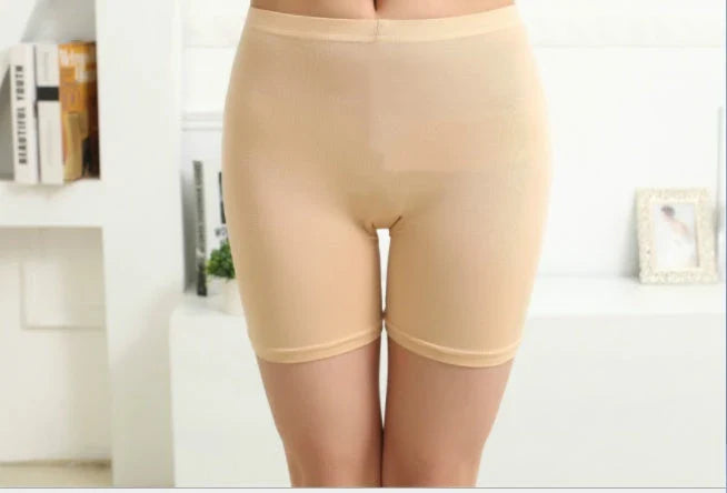 Luxurious silk leggings in black and natural shades, designed to flatter the figure with a light smoothing effect.