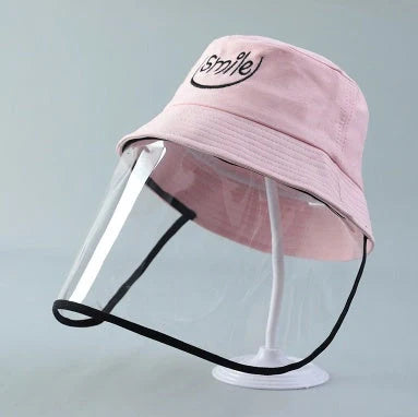Child wearing anti-spitting protective hat with transparent bezel