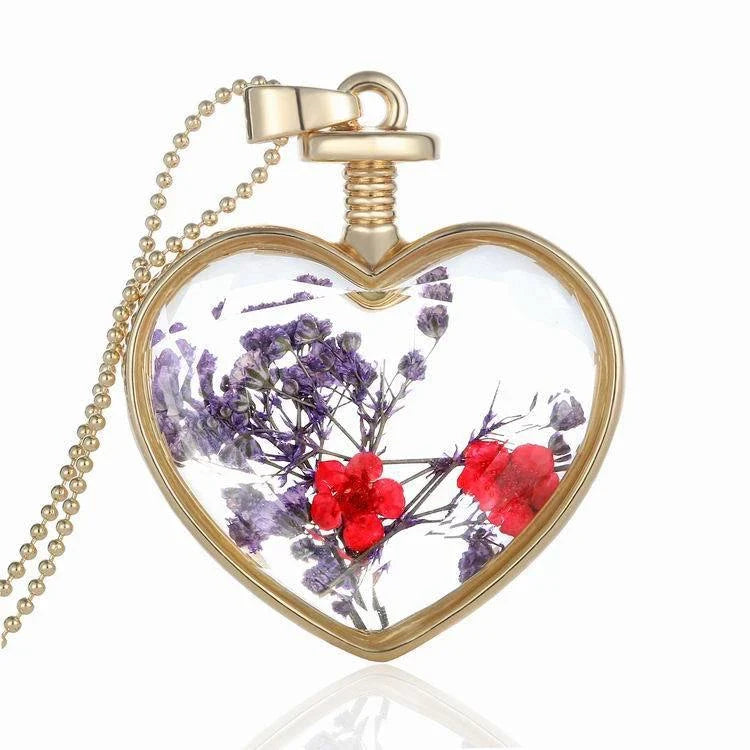 Elegant glass-encased dried flower pendant necklace with bead chain, showcasing a variety of preserved floral arrangements.