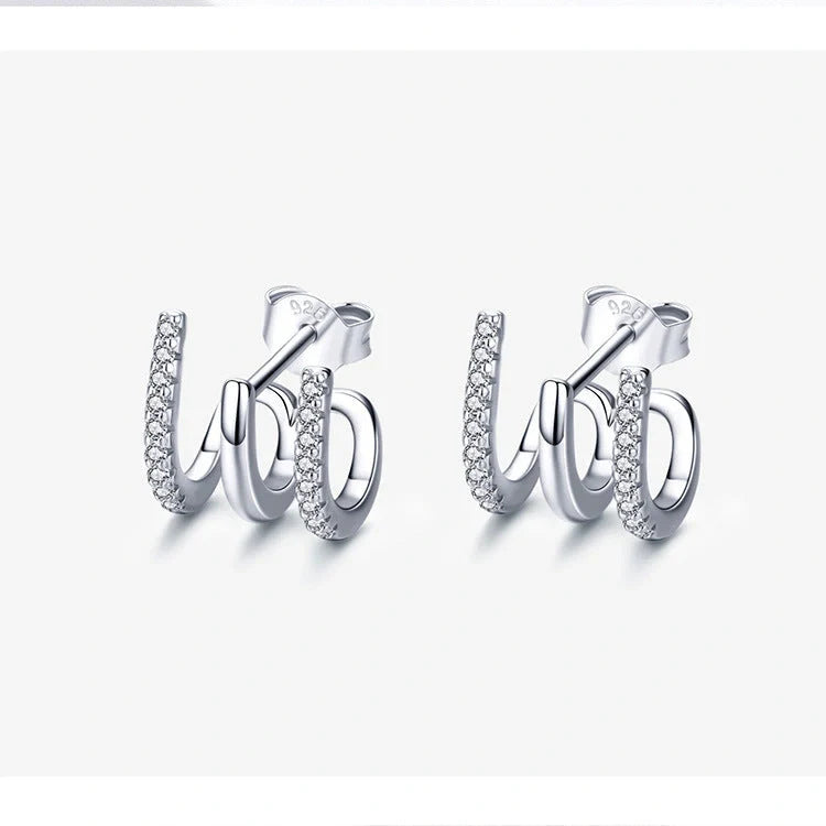 Elegant three-layer sterling silver heart earrings with sparkling gems, perfect for any occasion.