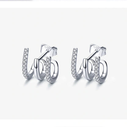 Elegant three-layer sterling silver heart earrings with sparkling gems, perfect for any occasion.
