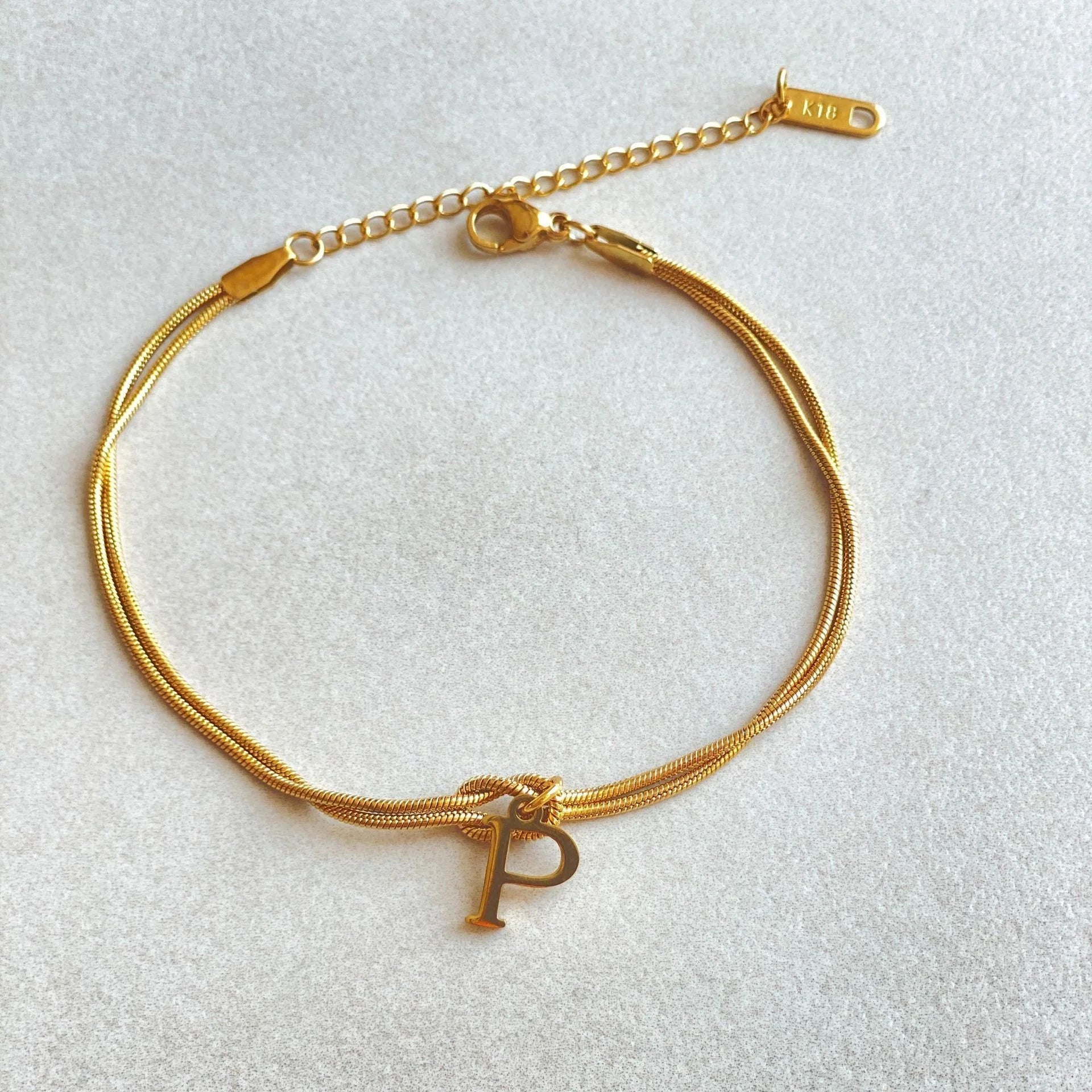 Personalised gold and silver love knot bracelets for couples, perfect as Valentine's Day gifts.