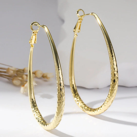 Golden egg-shaped hypoallergenic copper earrings with spring fastener