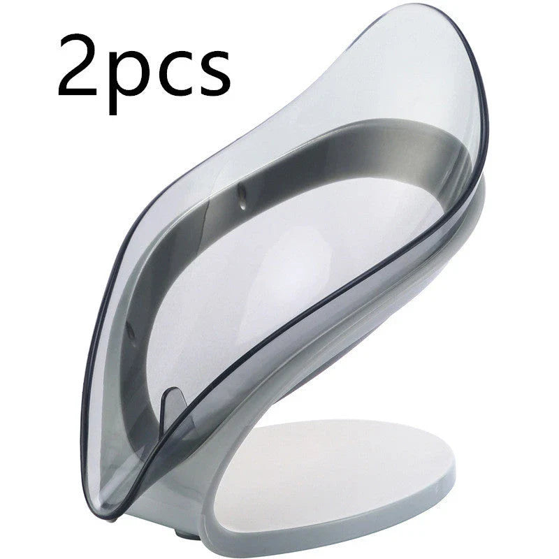 Elegant leaf-shaped soap dish with self-draining design and stable triangular shape, made of durable ABS material