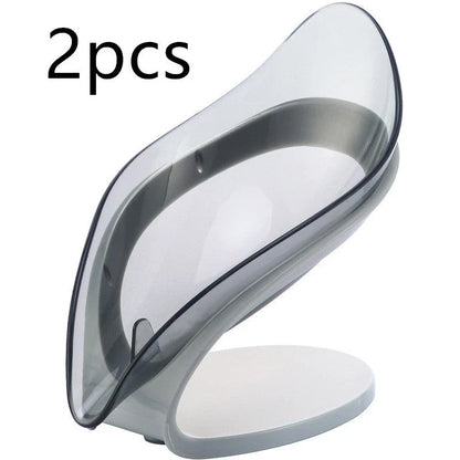 Elegant leaf-shaped soap dish with self-draining design and stable triangular shape, made of durable ABS material