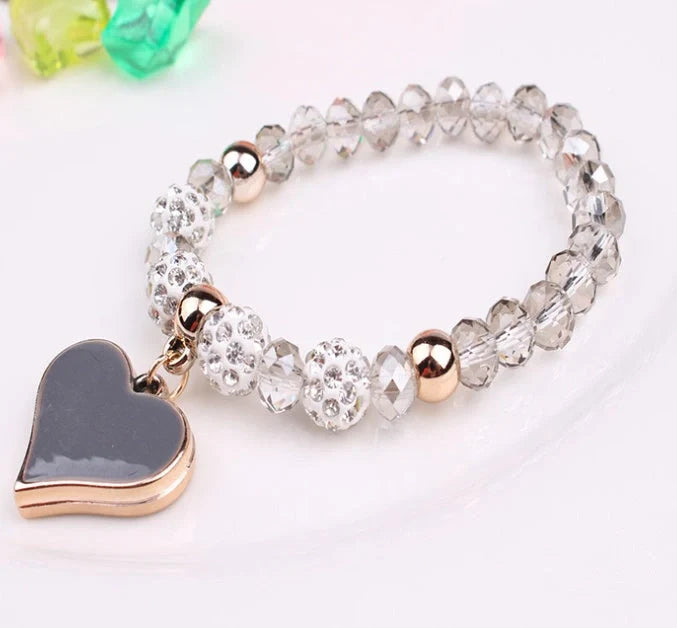 Elegant crystal heart-shaped bracelets in various vibrant colours, perfect for adding a touch of sophistication to any outfit