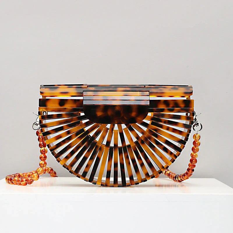 Stylish acrylic cross-body bag in various colors and strap designs, perfect for everyday use and fashion-forward British style.