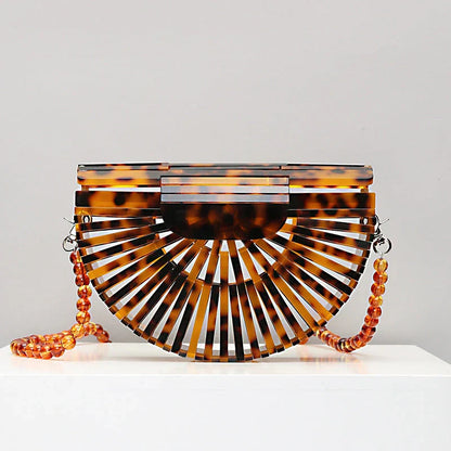 Stylish acrylic cross-body bag in various colors and strap designs, perfect for everyday use and fashion-forward British style.