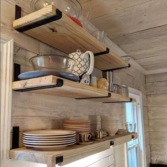 Sturdy black iron wall shelves in three sizes for displaying books, decor, and more in a rustic home setting