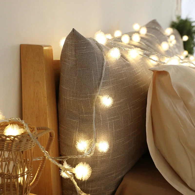 Battery-operated LED curtain garland with plastic stars and fur balls for festive decoration