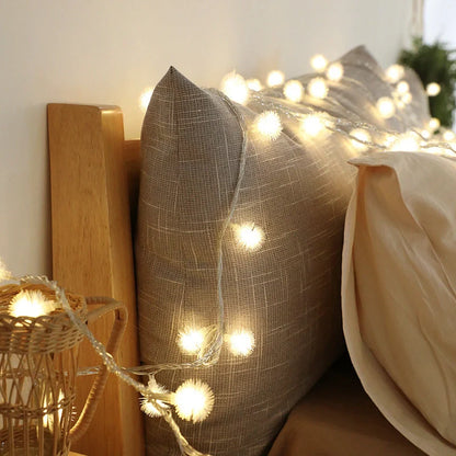 Battery-operated LED curtain garland with plastic stars and fur balls for festive decoration
