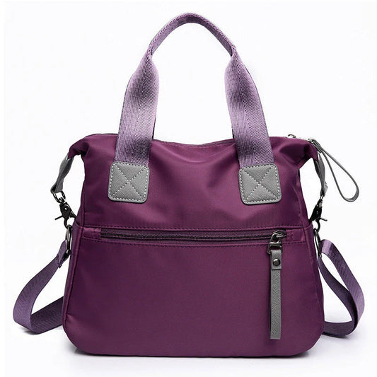Versatile ladies shoulder bag with multiple carry options, numerous pockets, and durable Oxford fabric construction