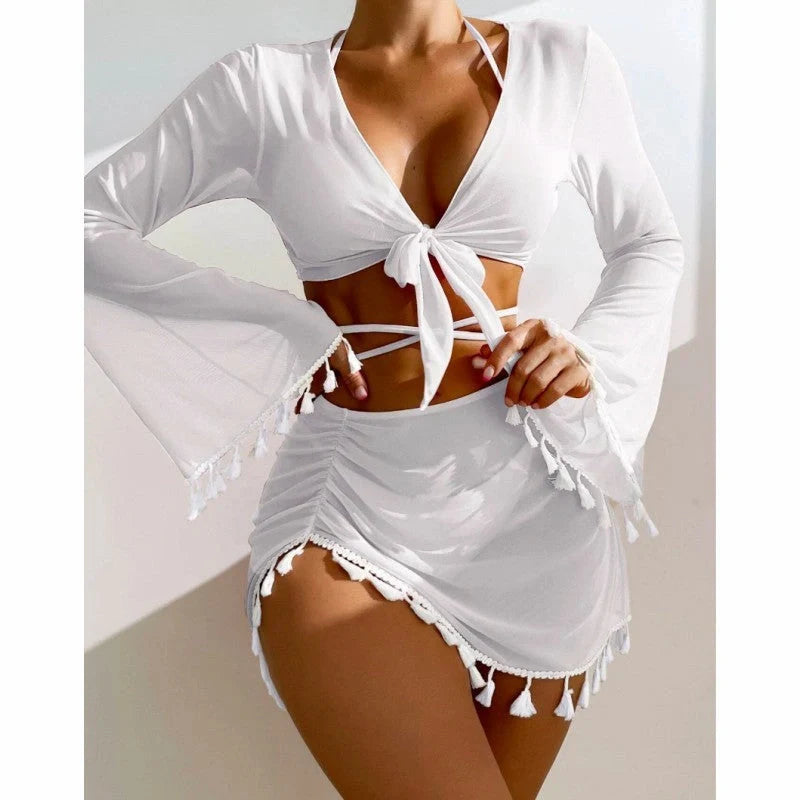 Solid colour bikini set with short skirt and long sleeve cover-up, featuring bow tie and fringe details