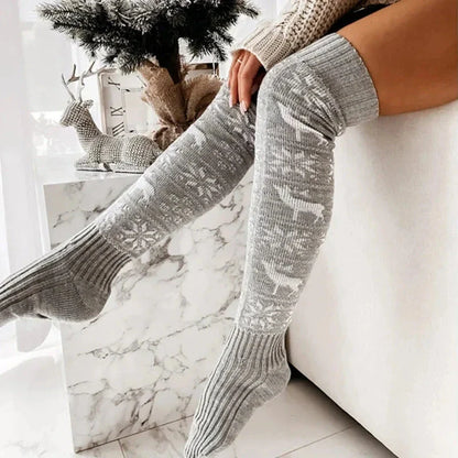 Cozy Christmas knee-high socks for women featuring a festive snowflake and reindeer pattern, designed to provide warmth and comfort during the winter season.