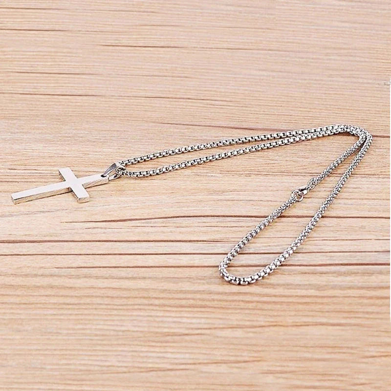 Stainless steel cross pendant necklace in black, silver, and gold colours, showcasing a classic and elegant design