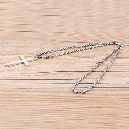 Stainless steel cross pendant necklace in black, silver, and gold colours, showcasing a classic and elegant design