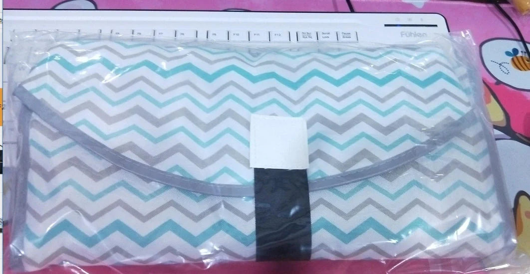 Portable diaper changing pad clutch with built-in toy ring, foldable design for easy transport
