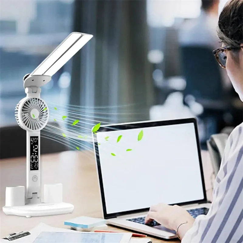 Foldable LED desk lamp with fan, thermometer, and pen holder on a tidy desk