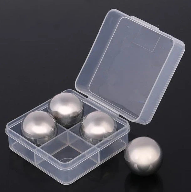 Premium stainless steel whisky chilling stones set in various shapes and sizes, including square, circular, heart, and diamond-shaped stones