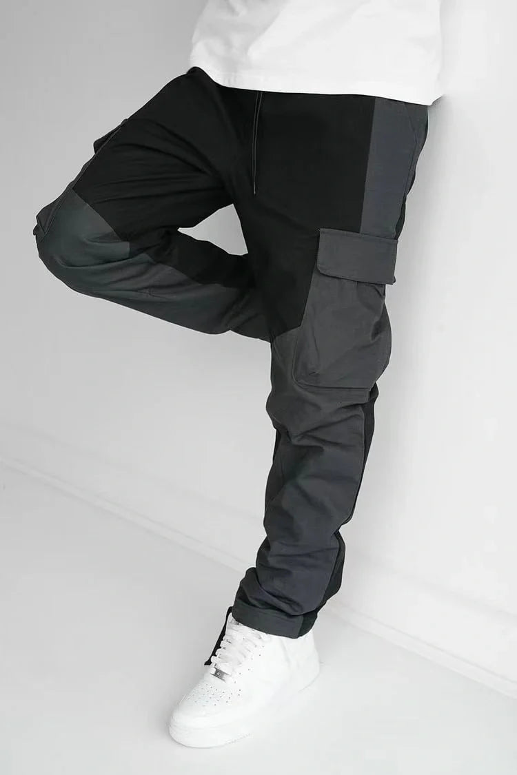 Men's large pocket stitching trousers in black and grey, featuring multiple pockets and a loose fit.