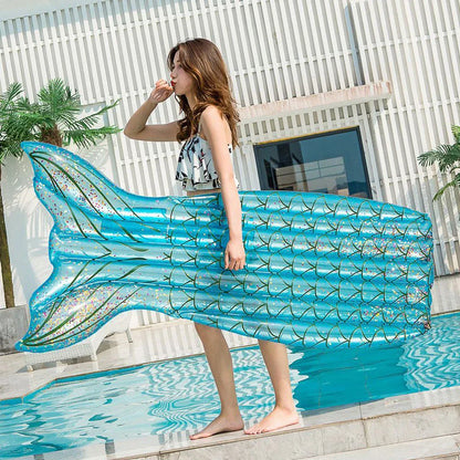 Mermaid-inspired inflatable pool lounger in vibrant blue and pink colours, offering a comfortable and stylish water relaxation experience.
