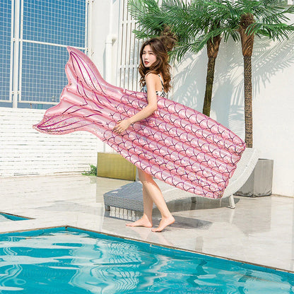 Mermaid-inspired inflatable pool lounger in vibrant blue and pink colours, offering a comfortable and stylish water relaxation experience.