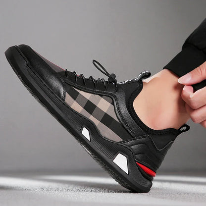 A pair of men's casual leather shoes with a sleek, lace-up design and a stylish check pattern.