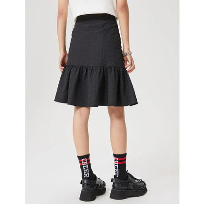 Metersbowne Jacquard Swallowtail Half Skirt Shorts in Black, featuring an embossed fabric design and a flattering silhouette for summer style.