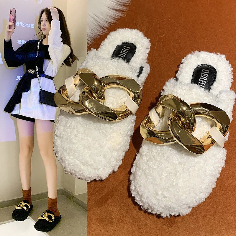 Furry wool mule slippers with a stylish metal chain detail, available in a range of colours to complement any outfit.