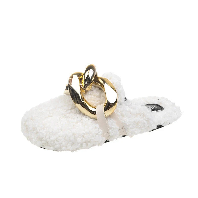 Furry wool mule slippers with a stylish metal chain detail, available in a range of colours to complement any outfit.