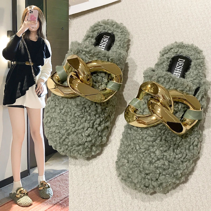 Furry wool mule slippers with a stylish metal chain detail, available in a range of colours to complement any outfit.