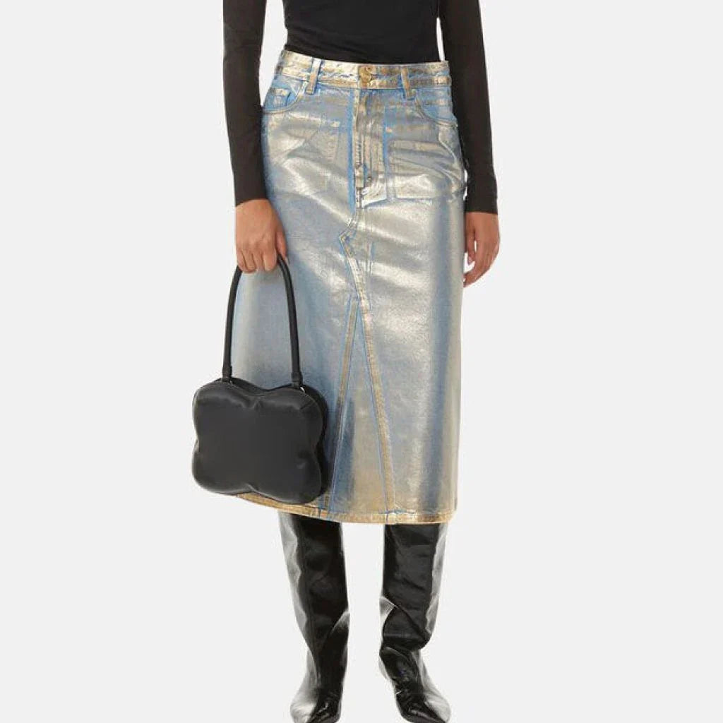 A high-waisted A-line denim skirt with a glossy finish and patchwork pattern, perfect for summer fashion.