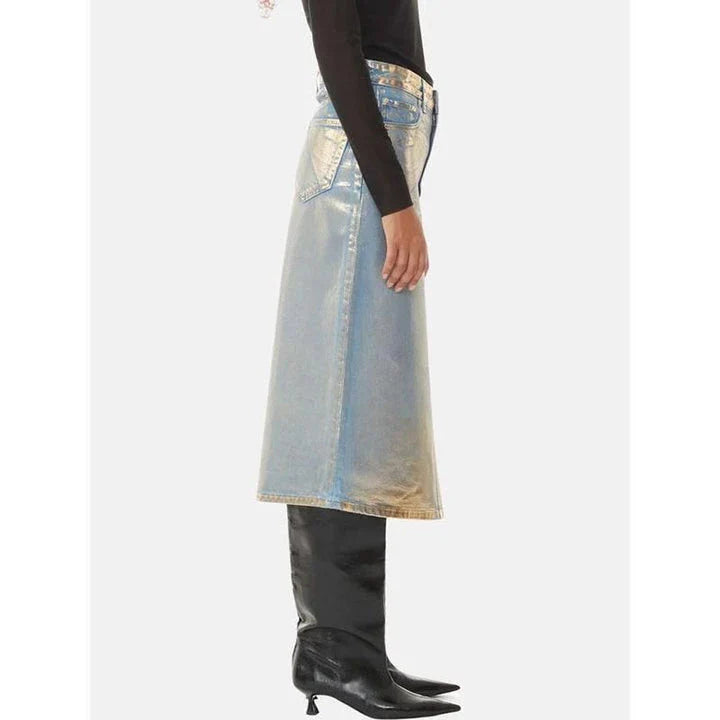 A high-waisted A-line denim skirt with a glossy finish and patchwork pattern, perfect for summer fashion.