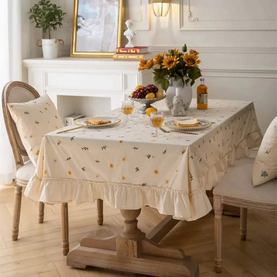 Elegant cotton apricot embroidered tablecloth with a folded lotus leaf edge, adding sophistication to any dining setting.