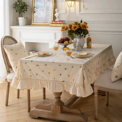 Elegant cotton apricot embroidered tablecloth with a folded lotus leaf edge, adding sophistication to any dining setting.