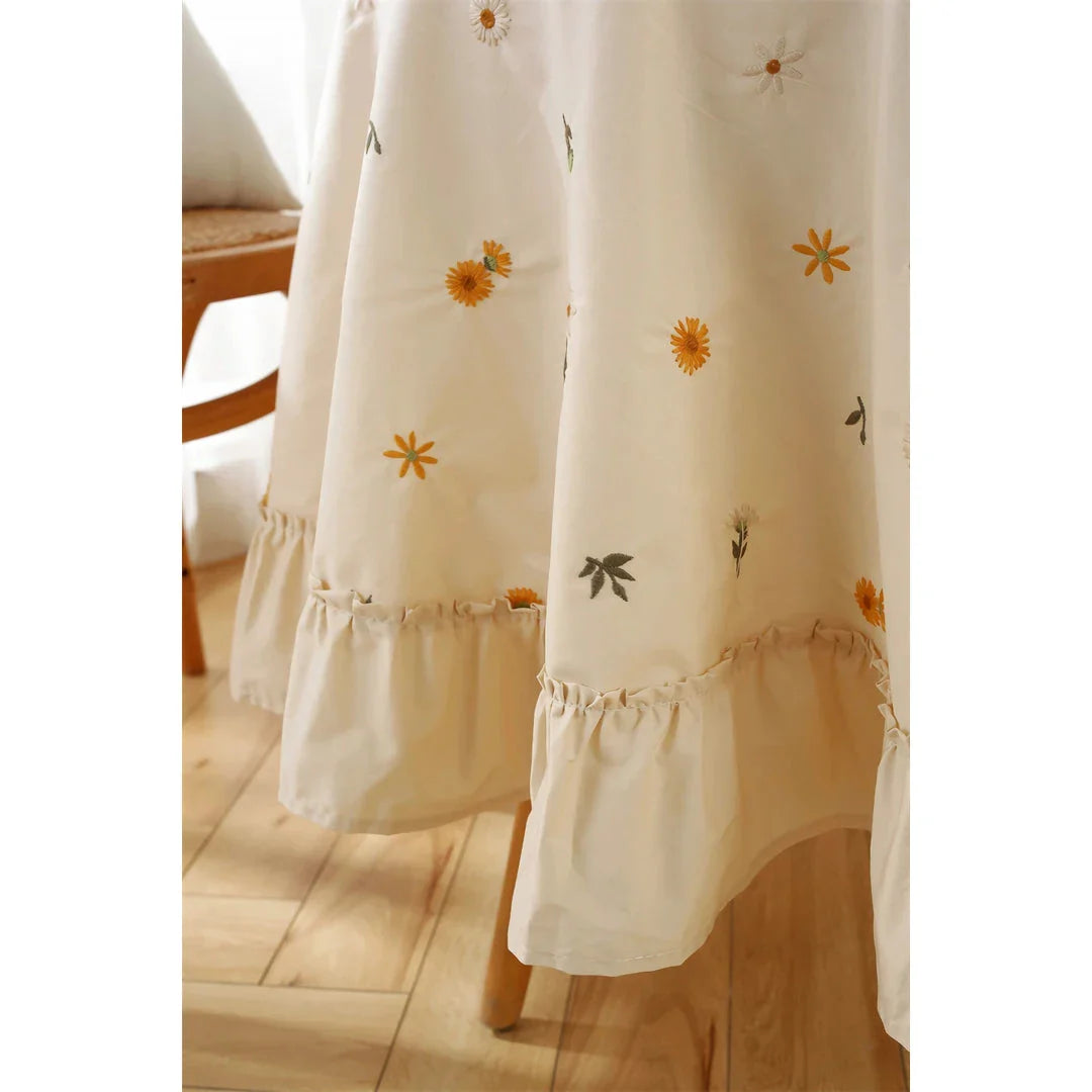 Elegant cotton apricot embroidered tablecloth with a folded lotus leaf edge, adding sophistication to any dining setting.