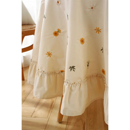 Elegant cotton apricot embroidered tablecloth with a folded lotus leaf edge, adding sophistication to any dining setting.