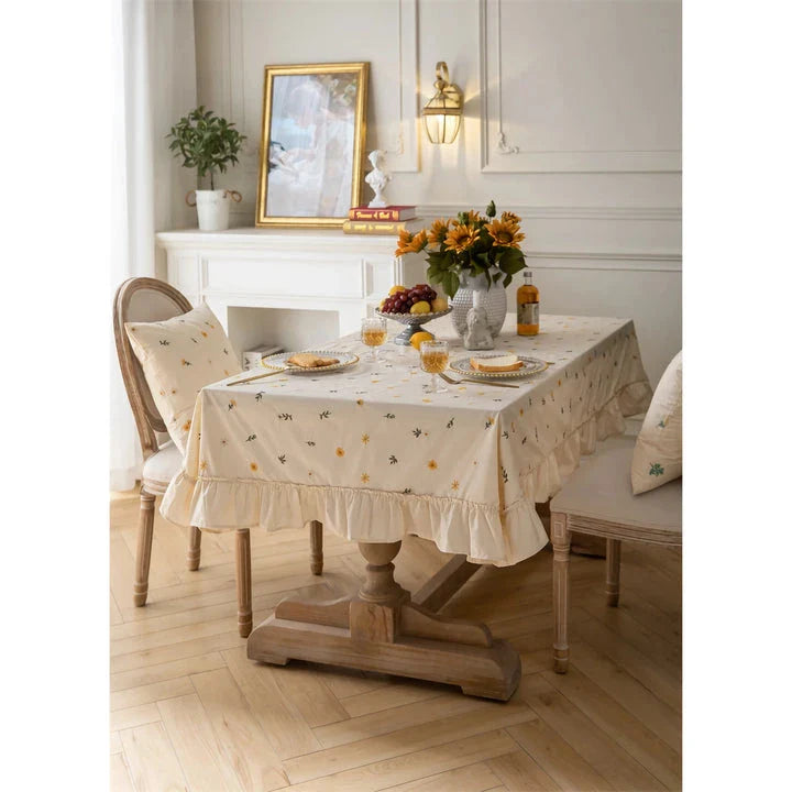 Elegant cotton apricot embroidered tablecloth with a folded lotus leaf edge, adding sophistication to any dining setting.