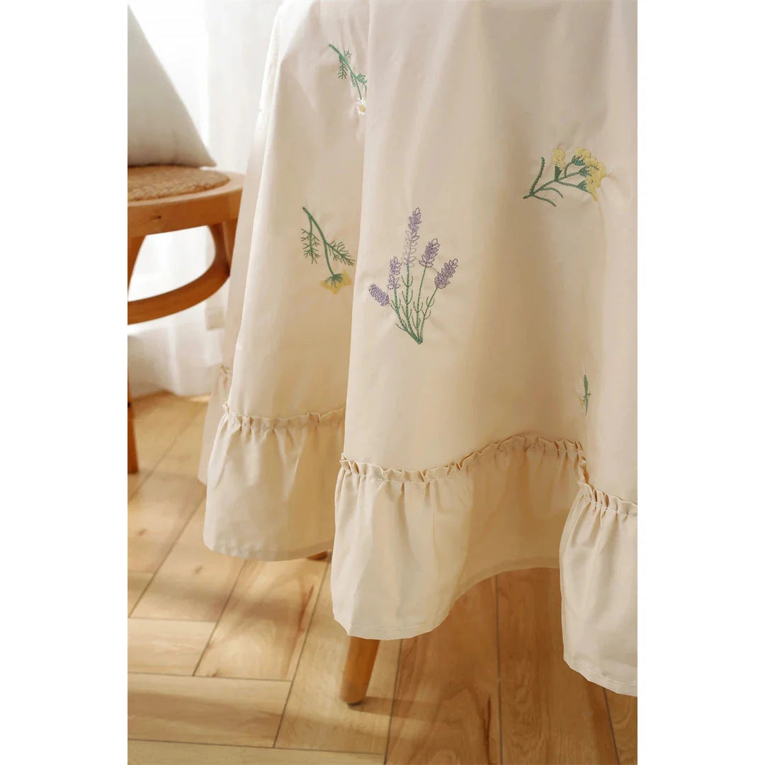 Elegant cotton apricot embroidered tablecloth with a folded lotus leaf edge, adding sophistication to any dining setting.