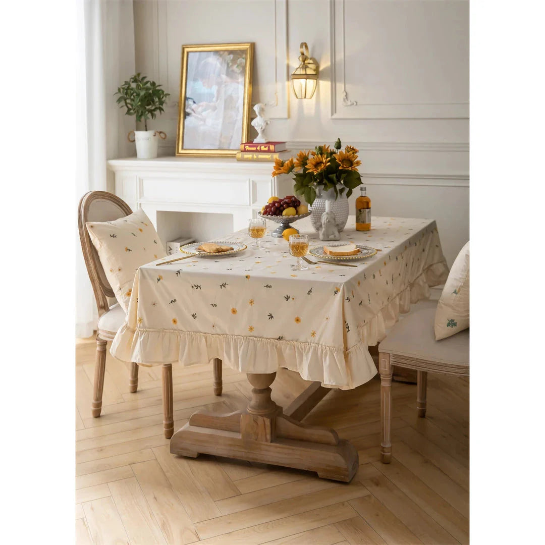 Elegant cotton apricot embroidered tablecloth with a folded lotus leaf edge, adding sophistication to any dining setting.