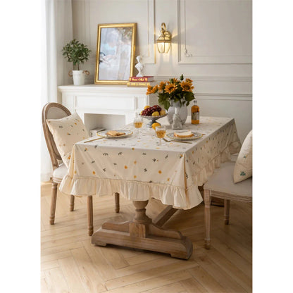Elegant cotton apricot embroidered tablecloth with a folded lotus leaf edge, adding sophistication to any dining setting.