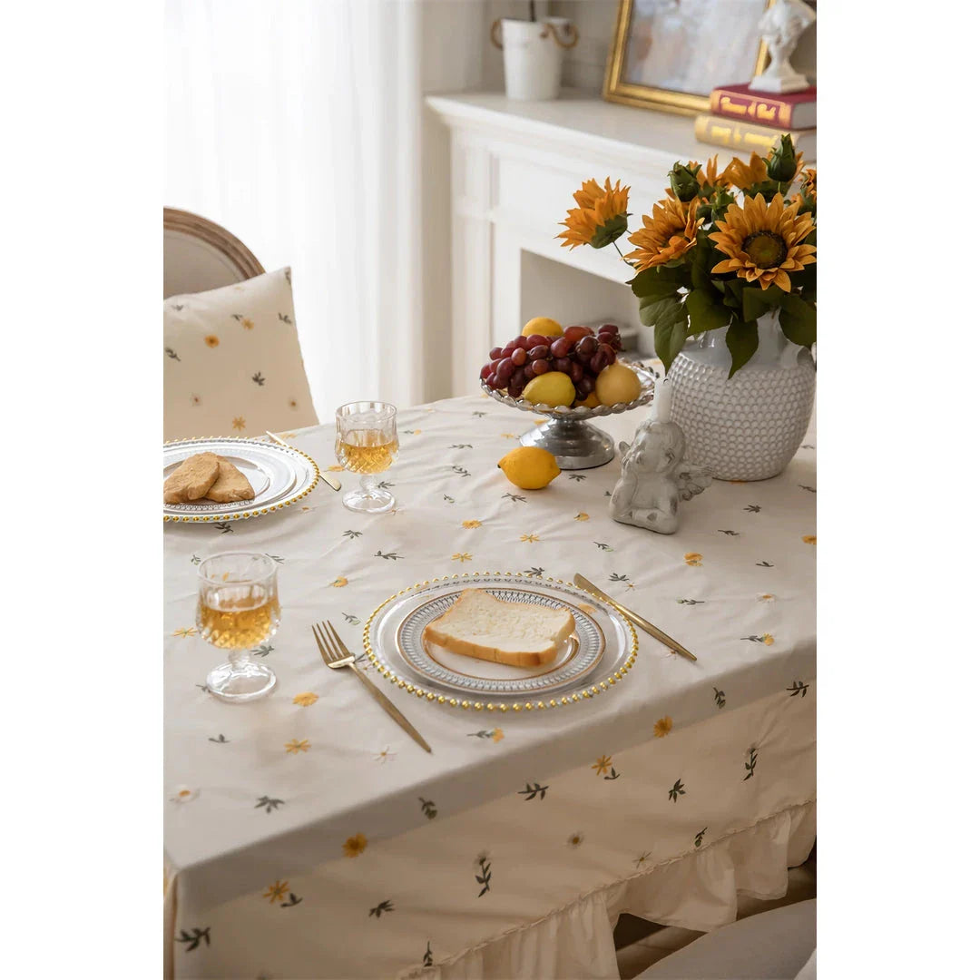 Elegant cotton apricot embroidered tablecloth with a folded lotus leaf edge, adding sophistication to any dining setting.